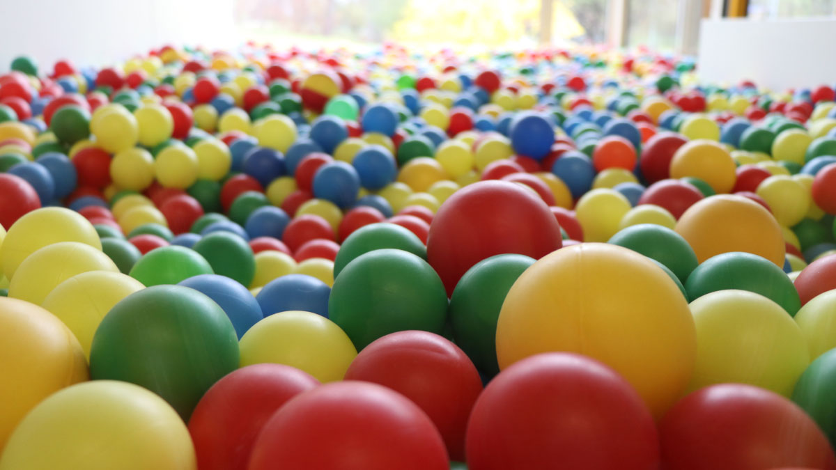 Ball pit with lots of colourful plastic balls.